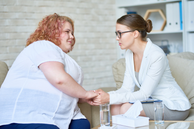 female psychiatrist offering psychological support to young woman